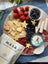 Ripe strawberries and blueberries, creamy brie, and savory ribbons of prosciutto and salami. Star-shaped cheese cutouts and a side of whipped herbed dip and MASA Chips.