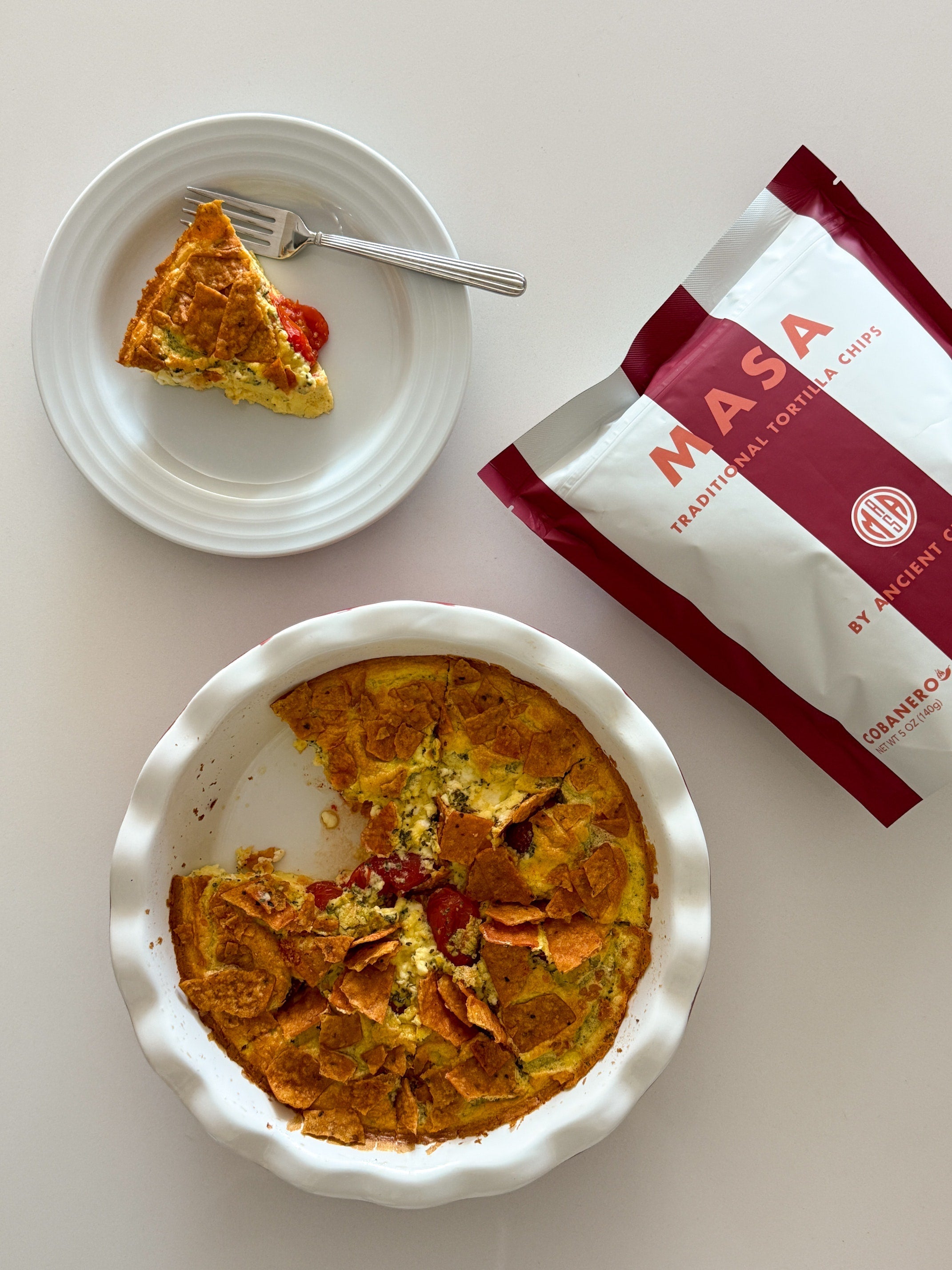 Light and fluffy egg frittata baked with savory feta and cherry tomatoes, then topped with crushed MASA Chips.