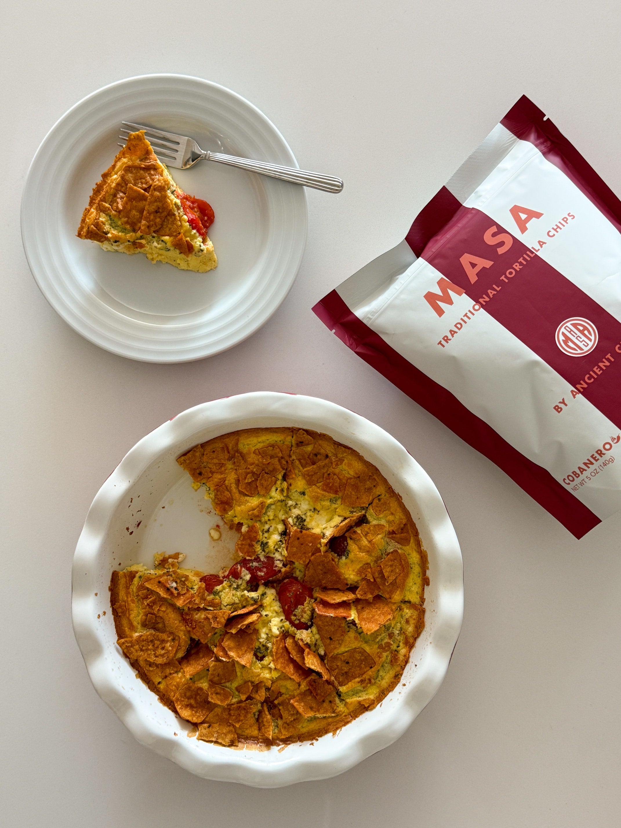 Light and fluffy egg frittata baked with savory feta and cherry tomatoes, then topped with crushed MASA Chips.